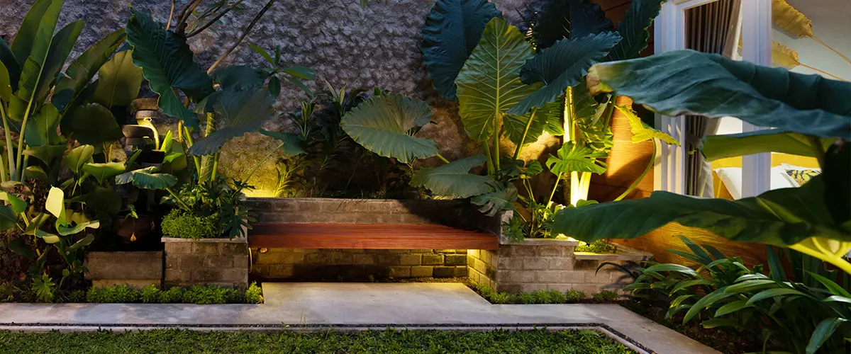 Beautiful outdoor space with exotic plants and a built in bench