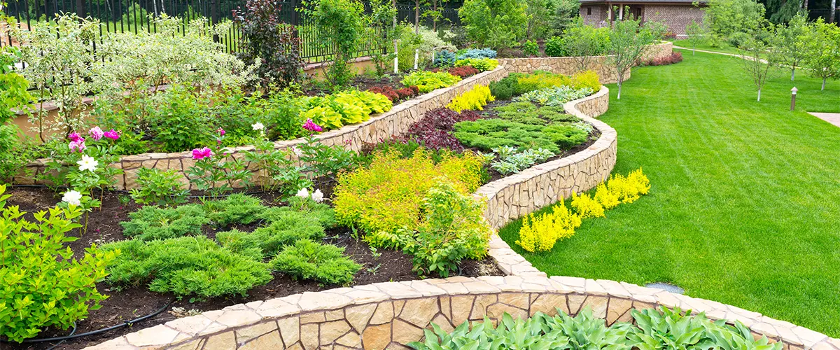 Beautiful landscape design with retaining walls and flower beds