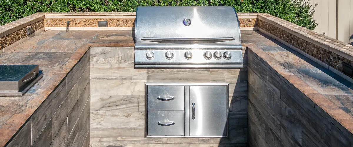 An outdoor kitchen with a grill