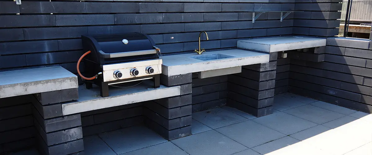 Outdoor kitchen with concrete slabs patio