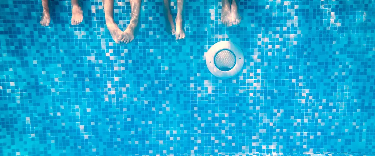 People hanging their feet in a pool