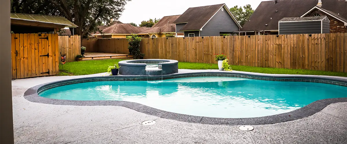 pool-in-backyard-with-wood-fence