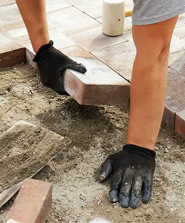 contractor installing paver patio in plano texas