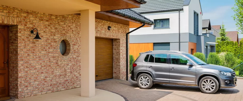 Residential house with silver suv car parked on driveway in front