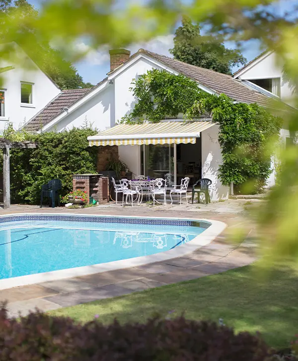 Swimming pool in backyard of house