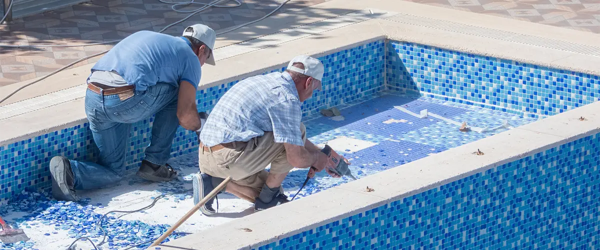 Two men doing pool renovation work.