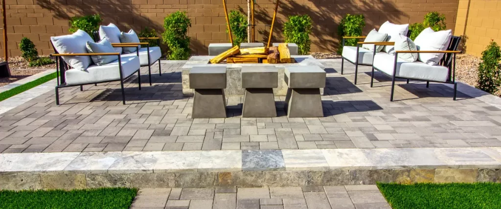 Modern stone patio with square fire pit and bench seating