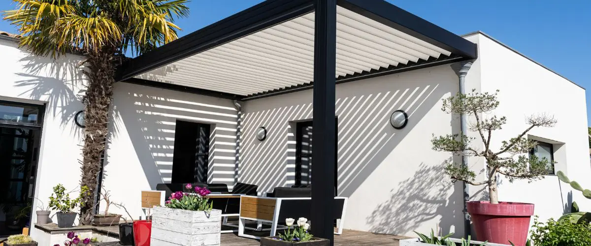 Modern louvered pergola attached to white villa patio