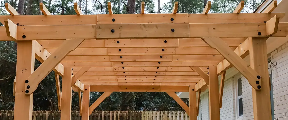 Natural wood pergola structure in a backyard setting
