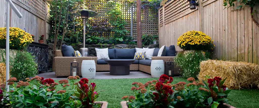 Cozy backyard lounge area with rattan furniture and potted flowers