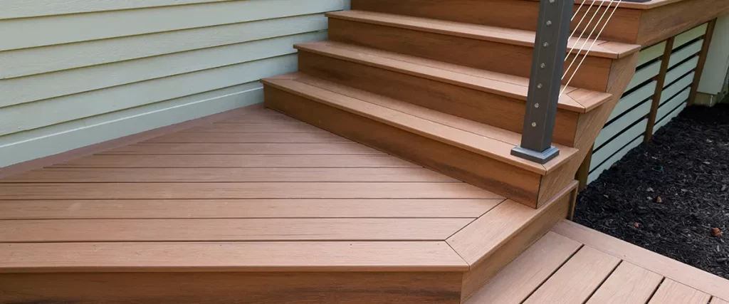 Brown composite deck stairs with cable railing system