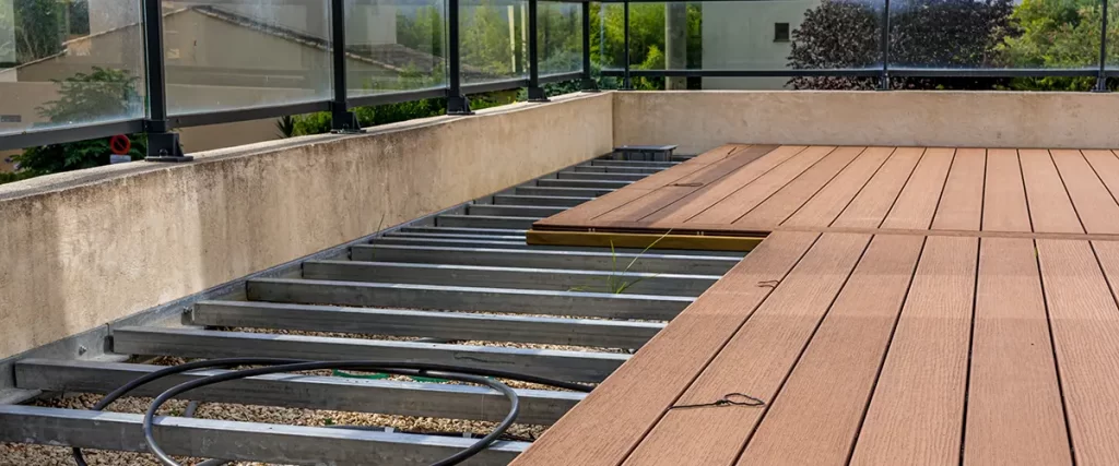 Deck installation in progress with metal frame and brown Trex composite boards