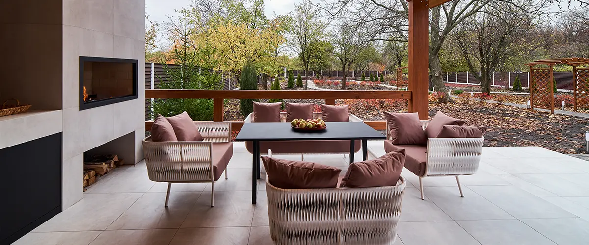 Cozy covered patio with fireplace and cushioned outdoor seating
