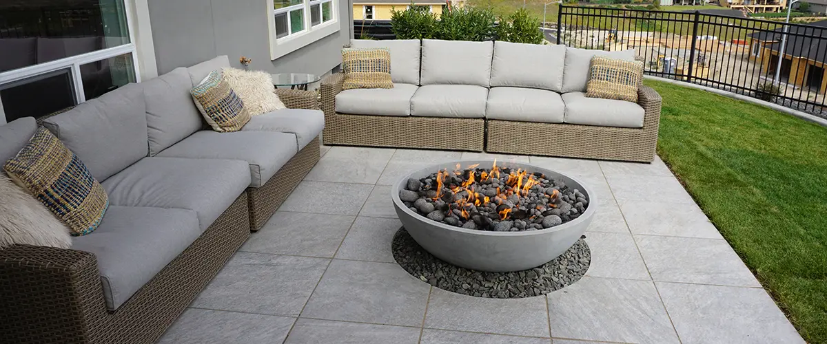 Circular fire bowl centerpiece with cushioned patio seating