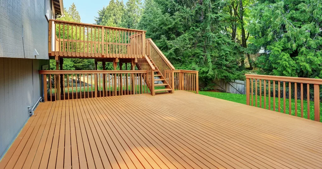 Large wooden deck with upper-level platform and stairs