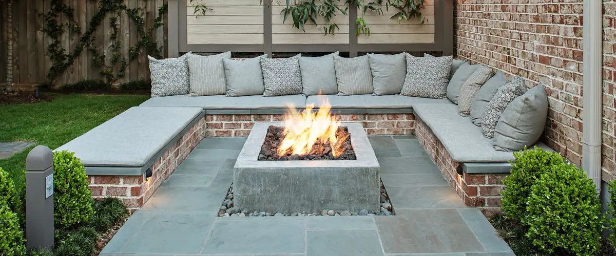 Modern outdoor fire pit with built-in corner seating