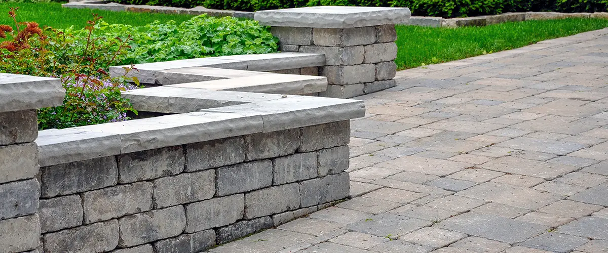 Retaining wall and paved patio with garden plants