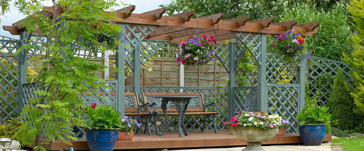 Backyard pergola with decorative lattice panels and flowers