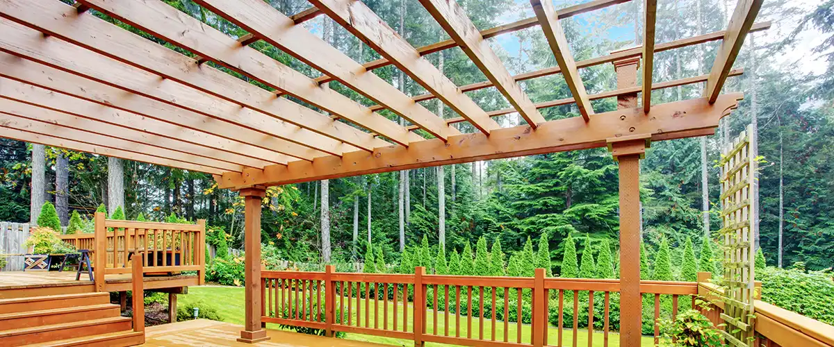 Large wooden pergola installed on a backyard deck