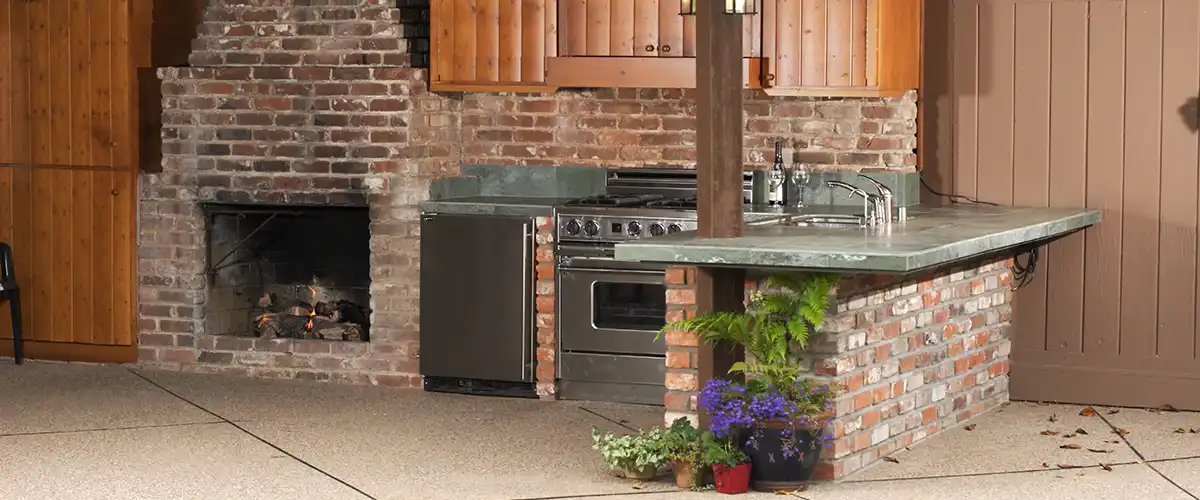 Rustic outdoor kitchen built with brick and green stone countertop