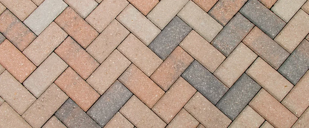 herringbone patterned brick pavers in earthy tones create durable outdoor flooring