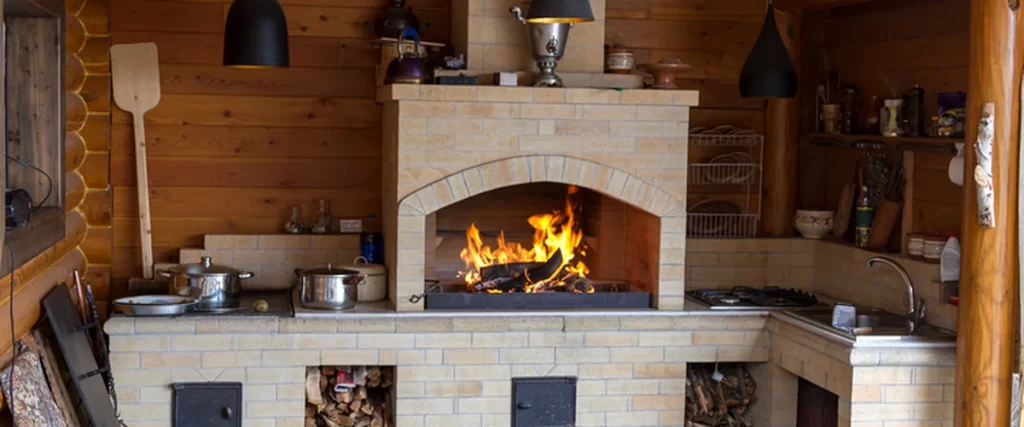 outdoor kitchens fireplaces outdoor kitchen with brick fireplace stainless steel appliances wooden cabinetry pendant lighting
