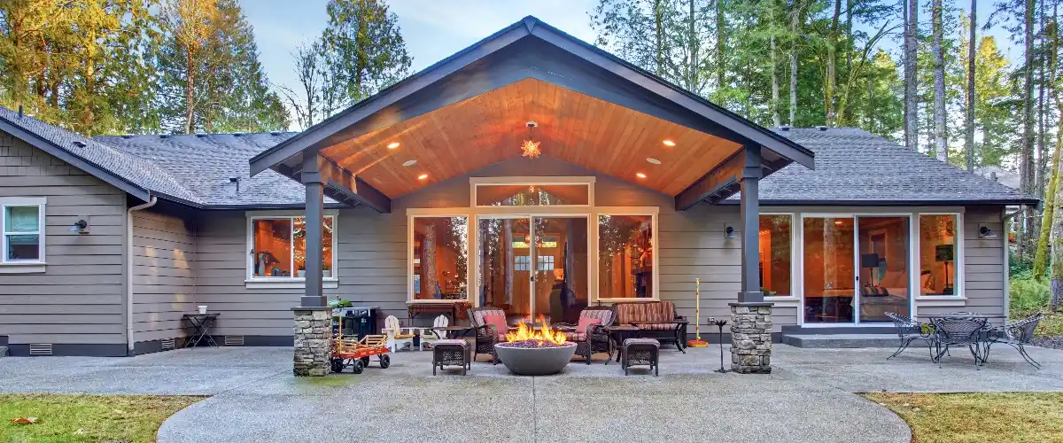 A cozy home featuring a covered patio and a fire pit, perfect for outdoor gatherings and relaxation.