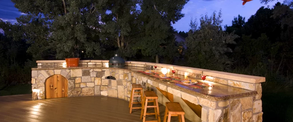 outdoor kitchens fireplaces expertly crafted outdoor kitchen with stone countertop wooden stools and ambient lighting