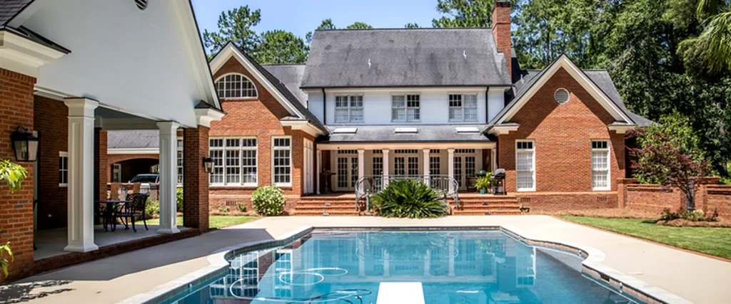 pool spa installation texas luxurious brick home with professionally installed in ground swimming pool surrounded by lush greenery