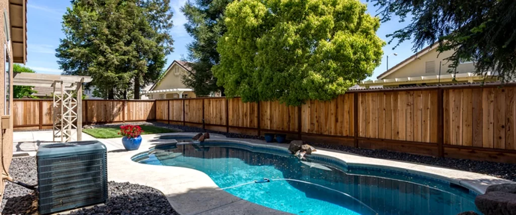 pool spa installation texas outdoor modern pool installation with curved design wooden fence lush trees