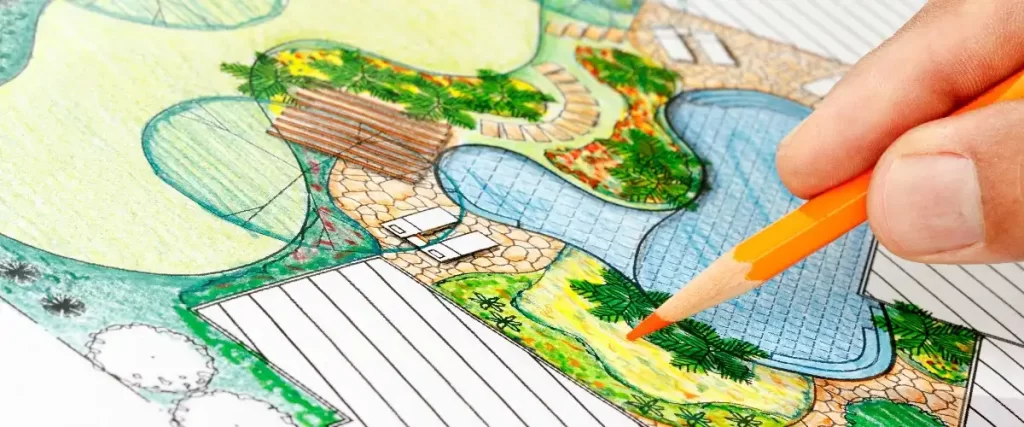 a person hand-drawing a landscape design plan with a colored pencil