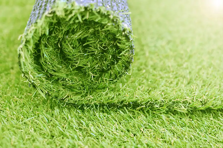 Close-up texture of artificial turf grass blades showing dense synthetic surface
