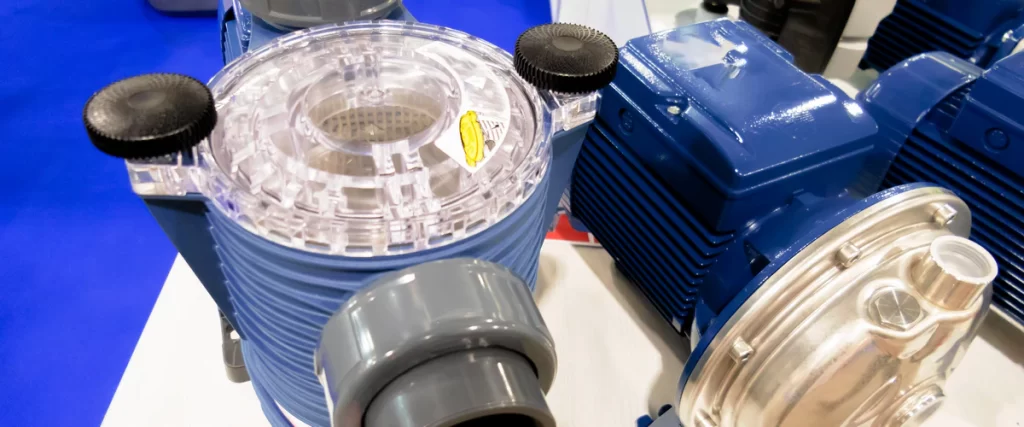 Close-up view of an energy-efficient blue pool pump and motor featuring a clear strainer lid, displayed at an exhibition.