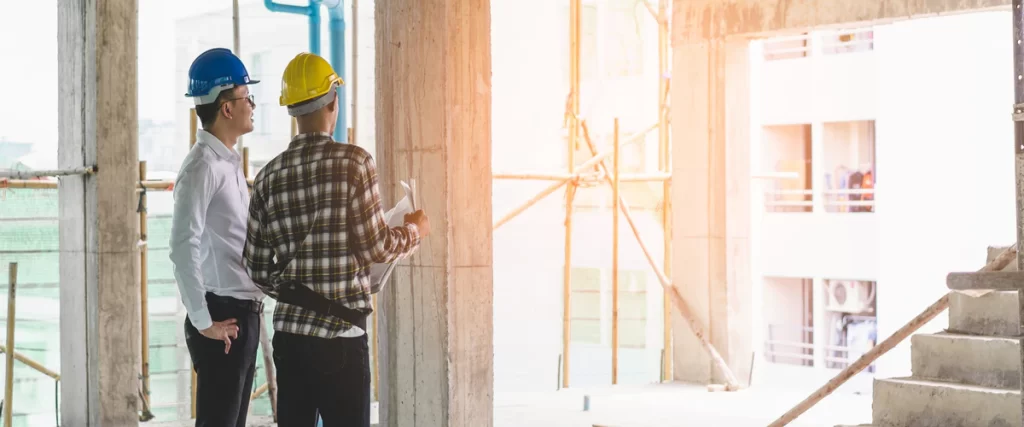An expert residential contractor carefully installing modern wooden cabinetry during a high-end kitchen remodel.