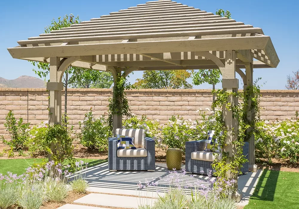 Wooden Pergola Pergola installation featuring a beautiful wooden pergola with seating area, surrounded by lush greenery